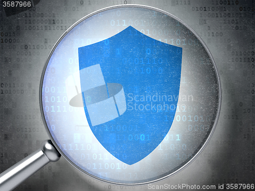 Image of Protection concept: Shield with optical glass on digital background