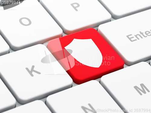 Image of Privacy concept: Shield on computer keyboard background