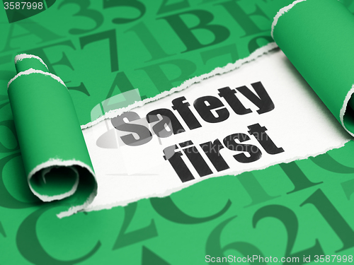 Image of Security concept: black text Safety First under the piece of  torn paper