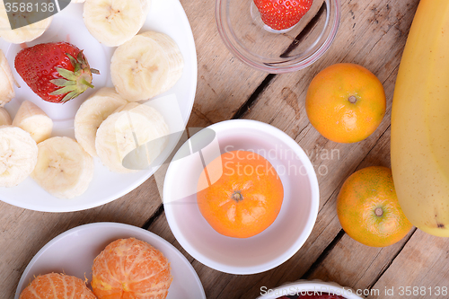 Image of Fresh colorful fruits composition mandarin, strawberry, peach, bananas and orange