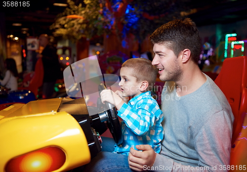 Image of father and son playing game in playground