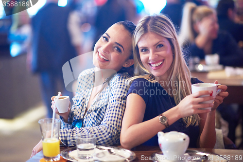 Image of girls have cup of coffee in restaurant