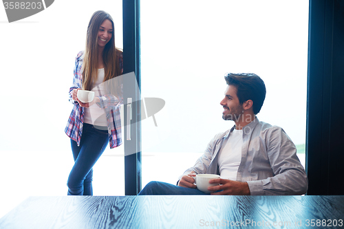 Image of relaxet young couple drink first morning coffee