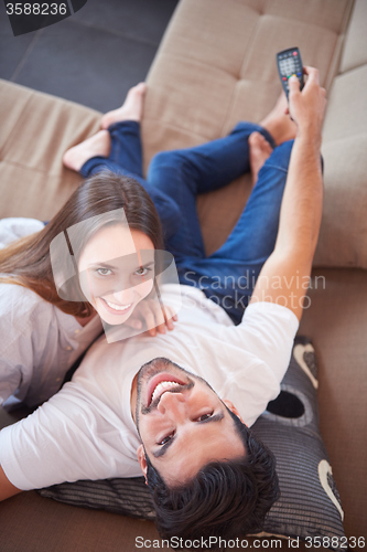 Image of young couple watching tv at home