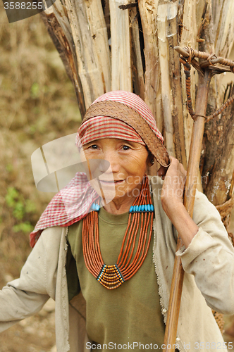 Image of Elderly woman carrying heavy load in Nagaland, India