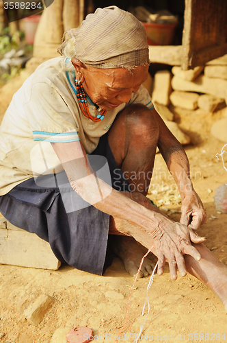 Image of Old woman at work in Nagaland, India