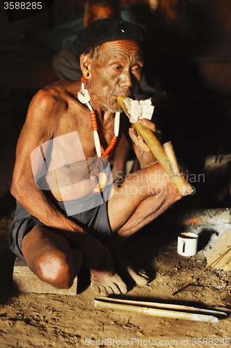 Image of Elder man smoking pipe in Nagaland, India