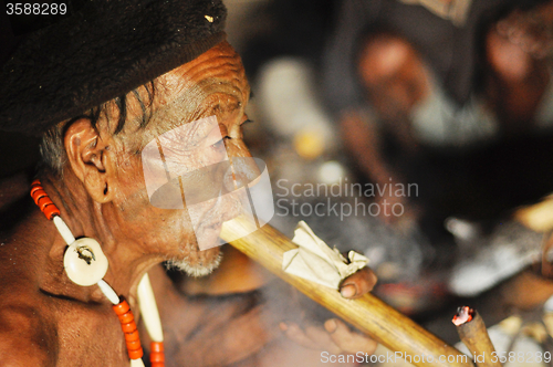 Image of Old man smoking pipe in Nagaland, India