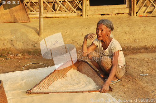 Image of Old woman sifting flour in Nagaland, India