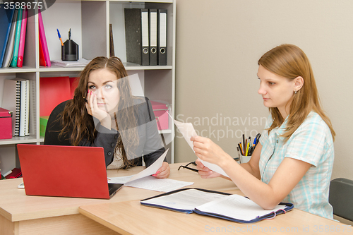 Image of Two women office workers laugh during the meeting