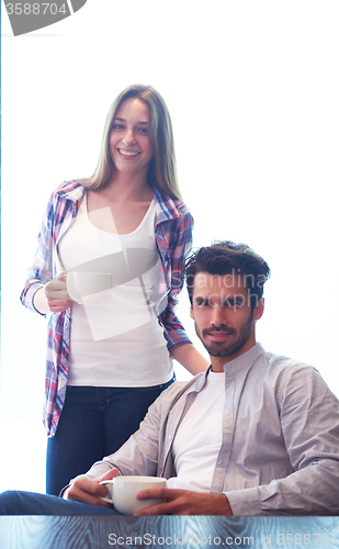 Image of relaxet young couple drink first morning coffee