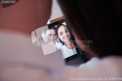Image of couple at modern home using tablet computer