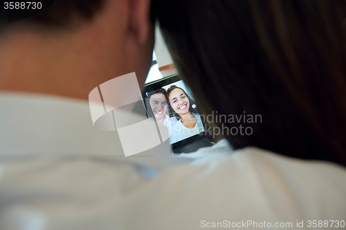Image of couple at modern home using tablet computer