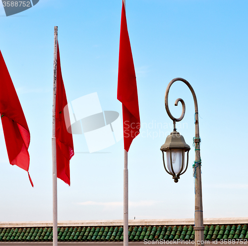 Image of tunisia  waving flag in the blue sky  colour and street lamp 