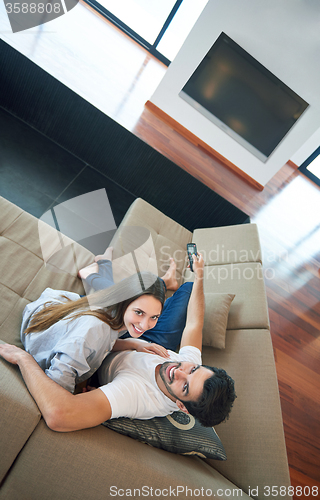 Image of young couple watching tv at home