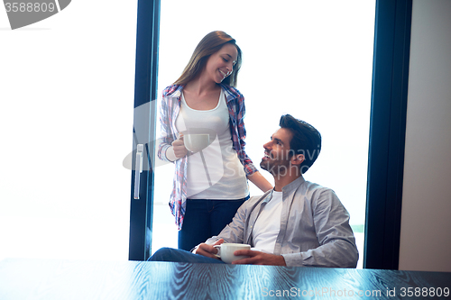 Image of relaxet young couple drink first morning coffee