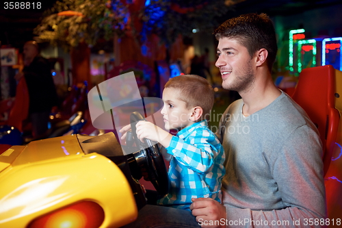 Image of father and son playing game in playground