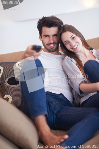 Image of young couple watching tv at home