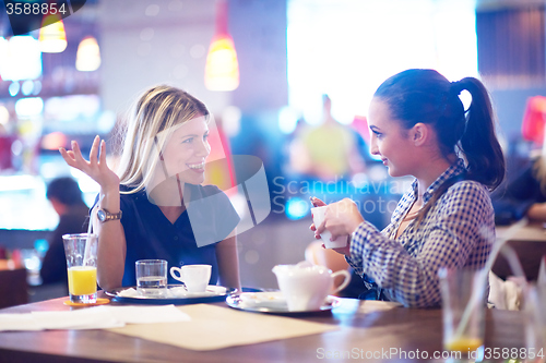 Image of girls have cup of coffee in restaurant