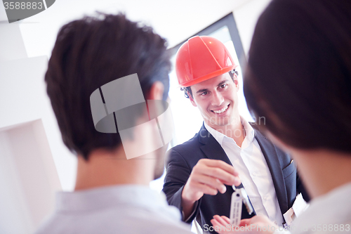 Image of couple buying new home with real estate agent