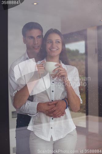 Image of relaxet young couple drink first morning coffee