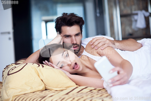 Image of couple relax and have fun in bed