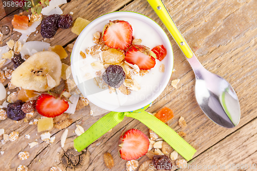 Image of yogurt with cereals muesli and fresh strawberries