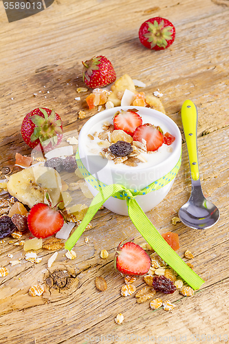 Image of yogurt with cereals muesli and fresh strawberries