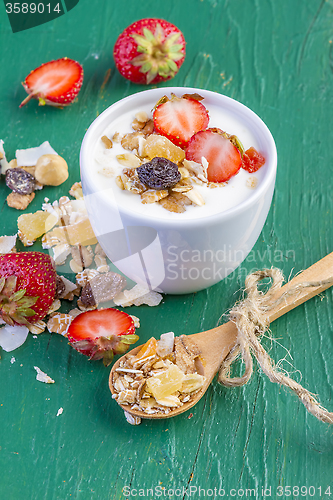 Image of yogurt with cereals muesli and fresh strawberries