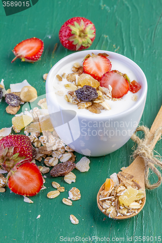 Image of yogurt with cereals muesli and fresh strawberries