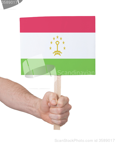 Image of Hand holding small card - Flag of Tajikistan