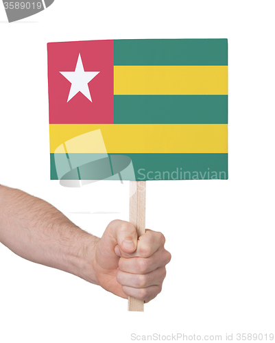 Image of Hand holding small card - Flag of Togo