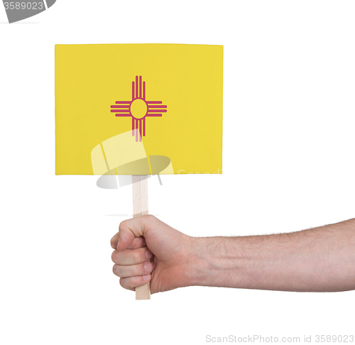 Image of Hand holding small card - Flag of New Mexico