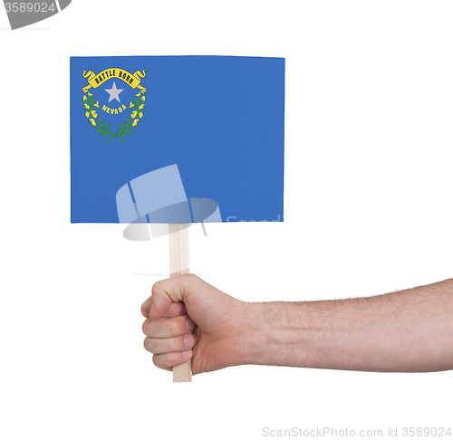 Image of Hand holding small card - Flag of Nevada