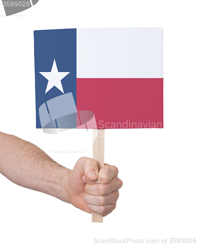 Image of Hand holding small card - Flag of Texas