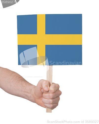 Image of Hand holding small card - Flag of Sweden