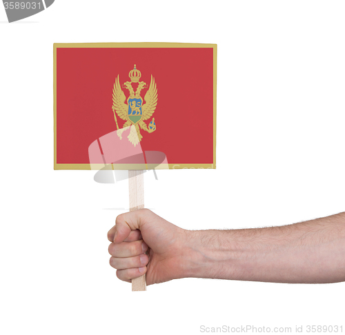 Image of Hand holding small card - Flag of Montenegro