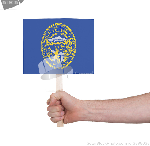 Image of Hand holding small card - Flag of Nebraska