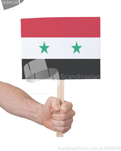 Image of Hand holding small card - Flag of Syria