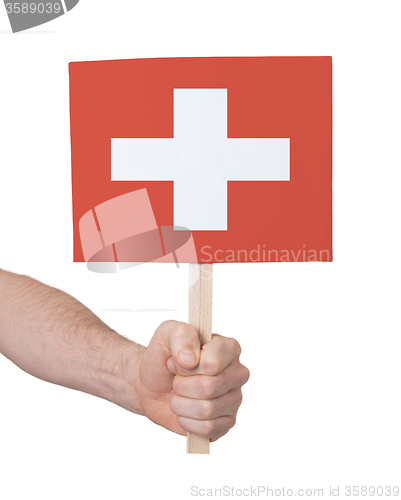 Image of Hand holding small card - Flag of Switzerland