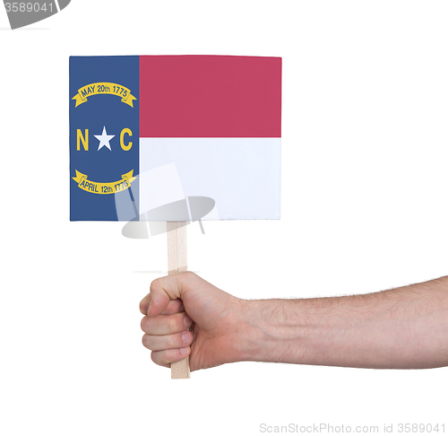 Image of Hand holding small card - Flag of North Carolina