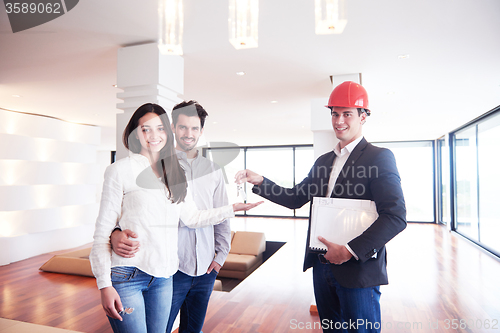 Image of couple buying new home with real estate agent