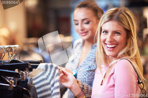 Image of happy young girls in  shopping mall