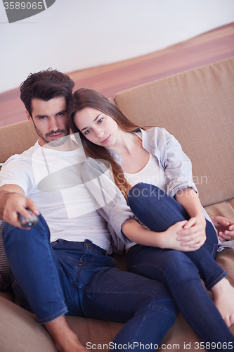 Image of young couple watching tv at home
