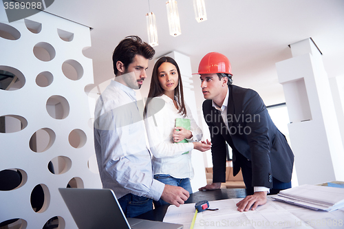 Image of couple buying new home with real estate agent