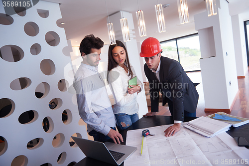 Image of couple buying new home with real estate agent