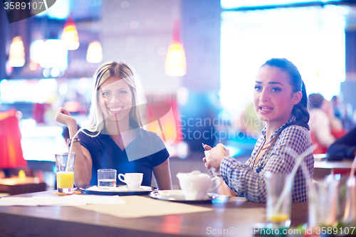 Image of girls have cup of coffee in restaurant