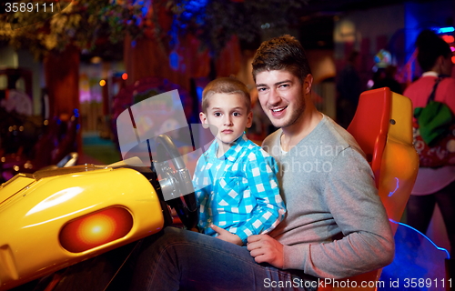 Image of father and son playing game in playground