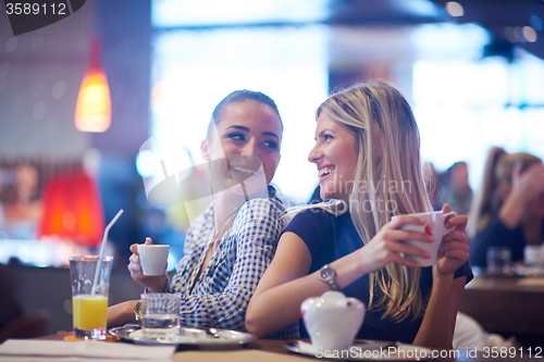 Image of girls have cup of coffee in restaurant