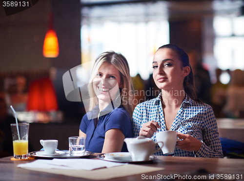 Image of girls have cup of coffee in restaurant